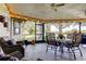 Enclosed patio with outdoor seating, ceiling fans and views of the backyard at 3410 Briarwood Ln, Safety Harbor, FL 34695