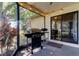 Enclosed patio area with barbecue grill and sliding glass door offering seamless indoor-outdoor living at 3410 Briarwood Ln, Safety Harbor, FL 34695