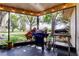 Enclosed patio featuring a grill, ceiling fans, and string lights for ambiance at 3410 Briarwood Ln, Safety Harbor, FL 34695