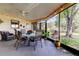 Enclosed patio featuring outdoor seating, ceiling fans and string lights at 3410 Briarwood Ln, Safety Harbor, FL 34695