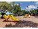 Community playground with bright yellow slides, climbing structures, and a covered picnic area at 3410 Briarwood Ln, Safety Harbor, FL 34695