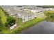 Aerial view of a house and pond in a community, showcasing lush landscaping at 3446 Suncoast Plains Dr, Odessa, FL 33556