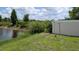 Backyard view with a tranquil pond and lush green landscaping at 3446 Suncoast Plains Dr, Odessa, FL 33556