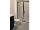Well-lit bathroom featuring a glass shower enclosure with black trim and modern fixtures at 3446 Suncoast Plains Dr, Odessa, FL 33556