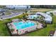 Aerial view of a community pool with a sundeck, lounge chairs, and landscaped grounds at 3446 Suncoast Plains Dr, Odessa, FL 33556