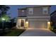 Charming two-story home with a two-car garage and inviting landscape lighting at 3446 Suncoast Plains Dr, Odessa, FL 33556