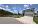 Charming home with a lake view, complemented by a well-maintained lawn and driveway at 3446 Suncoast Plains Dr, Odessa, FL 33556