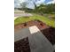 Landscaped front yard featuring a small palm tree and fresh mulch, a beautiful home exterior at 3446 Suncoast Plains Dr, Odessa, FL 33556