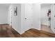 Hallway with wood flooring and well-lit closet space at 3446 Suncoast Plains Dr, Odessa, FL 33556