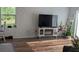 Comfortable living room with brick accent wall and view of the outdoors at 3446 Suncoast Plains Dr, Odessa, FL 33556