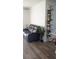 Living room with a comfortable recliner and stylish decorative shelving at 3446 Suncoast Plains Dr, Odessa, FL 33556