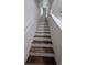 Bright stairway with wood and white risers leads upstairs in this inviting home at 3446 Suncoast Plains Dr, Odessa, FL 33556