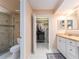 Bright bathroom showcasing a walk-in shower, vanity with ample storage, and access to a walk-in closet at 3455 Countryside Blvd # 101, Clearwater, FL 33761