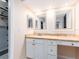 Bathroom featuring a vanity with double mirrors, ample counter space, and a built-in desk at 3455 Countryside Blvd # 101, Clearwater, FL 33761