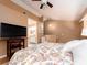 Comfortable bedroom with wood floors, a ceiling fan, and convenient access to the bathroom at 3455 Countryside Blvd # 101, Clearwater, FL 33761