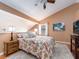 Cozy bedroom featuring wood floors, a ceiling fan, and ample natural light at 3455 Countryside Blvd # 101, Clearwater, FL 33761