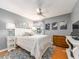 Comfortable bedroom featuring a ceiling fan, decorative artwork and a wooden dresser at 3455 Countryside Blvd # 101, Clearwater, FL 33761