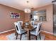 Comfortable dining area featuring wood floors, decorative art, and granite countertop access to the kitchen at 3455 Countryside Blvd # 101, Clearwater, FL 33761