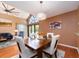 Lovely dining room with wood floors, modern lighting and large doors to the outdoors at 3455 Countryside Blvd # 101, Clearwater, FL 33761