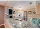 Bright kitchen featuring granite countertops, stainless steel appliances, and a breakfast bar at 3455 Countryside Blvd # 101, Clearwater, FL 33761