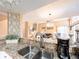 Open-concept kitchen featuring granite countertops and a breakfast bar that overlooks the living room at 3455 Countryside Blvd # 101, Clearwater, FL 33761
