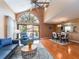 Open-concept living space with hardwood floors, a dining area, and ample natural light from large windows at 3455 Countryside Blvd # 101, Clearwater, FL 33761