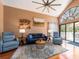 Bright living room with high ceilings, hardwood floors, and stylish furnishings, perfect for relaxation at 3455 Countryside Blvd # 101, Clearwater, FL 33761