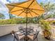 Serene outdoor patio with comfortable seating and a large umbrella, ideal for relaxation at 3455 Countryside Blvd # 101, Clearwater, FL 33761