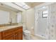 Clean bathroom with granite vanity, a toilet, and an enclosed shower with white tiles at 3617 Yellow Pine Ct # 144, Sarasota, FL 34238