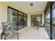 Enclosed porch with tiled floor and chairs overlooking the interior of the home at 3617 Yellow Pine Ct # 144, Sarasota, FL 34238