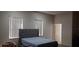 Bedroom with a padded headboard bed, carpet, and window at 3680 19Th S Ave, St Petersburg, FL 33711
