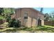 Side exterior view displaying the home's exterior walls, windows, and partial backyard with lawn at 3680 19Th S Ave, St Petersburg, FL 33711
