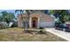 Charming single-Gathering home featuring a well-kept yard, attached garage, and inviting entryway with red door at 3680 19Th S Ave, St Petersburg, FL 33711
