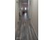 Hallway featuring laminate flooring, white trim, and natural light at 3680 19Th S Ave, St Petersburg, FL 33711
