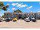 Well-maintained gray two-story condo building showcasing ample parking space under a partly cloudy sky at 4032 Cortez Dr # A, Tampa, FL 33614