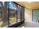 Enclosed screened-in porch with tile floor and large tree visible, great for enjoying the outdoors at 4032 Cortez Dr # A, Tampa, FL 33614