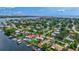 Stunning aerial view of a waterfront home in a lush neighborhood, with a private dock and easy access to the bay at 4099 Pompano Se Dr, St Petersburg, FL 33705