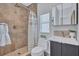 Tiled bathroom featuring a glass-enclosed shower, modern fixtures, and a vanity with storage at 4099 Pompano Se Dr, St Petersburg, FL 33705