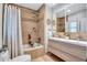 Stylish bathroom with modern vanity, bathtub with shower, and decorative tile accent at 4099 Pompano Se Dr, St Petersburg, FL 33705