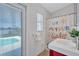 Bright bathroom featuring a vibrant vanity and direct access to the refreshing pool area at 4099 Pompano Se Dr, St Petersburg, FL 33705