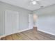 Bright bedroom featuring wood-look floors, neutral paint, and closet at 4099 Pompano Se Dr, St Petersburg, FL 33705