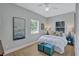 Bright bedroom with warm natural light, featuring a bed with blue accents and matching decor at 4099 Pompano Se Dr, St Petersburg, FL 33705