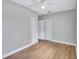Spacious bedroom with wood-look floors, neutral paint, and closet at 4099 Pompano Se Dr, St Petersburg, FL 33705