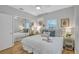 Bright bedroom featuring cool color palette, ceiling fan, and sliding door closet at 4099 Pompano Se Dr, St Petersburg, FL 33705