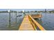 Private wooden boat dock with a boat lift, with waterfront views of the canal at 4099 Pompano Se Dr, St Petersburg, FL 33705