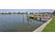 Waterfront property showcasing a private wooden dock with boat lift and canopy over blue water at 4099 Pompano Se Dr, St Petersburg, FL 33705