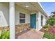 Inviting front porch with a colorful front door and stone accents, providing a warm welcome at 4099 Pompano Se Dr, St Petersburg, FL 33705