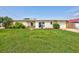 Charming home with a well-maintained lawn and stone accents, complemented by vibrant landscaping at 4099 Pompano Se Dr, St Petersburg, FL 33705