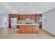 Modern kitchen featuring wood cabinets, stainless steel appliances, and a central island, designed for culinary enthusiasts at 4099 Pompano Se Dr, St Petersburg, FL 33705
