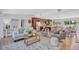 Bright, open-concept living room with hardwood floors, modern furnishings and stainless steel appliances at 4099 Pompano Se Dr, St Petersburg, FL 33705